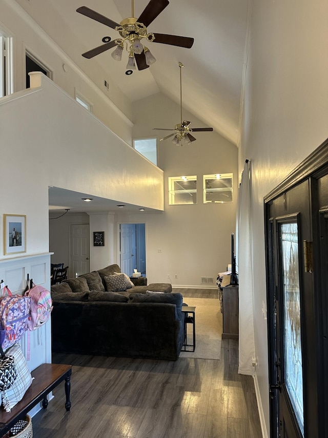 living room with high vaulted ceiling and dark hardwood / wood-style flooring