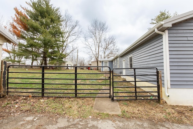 view of gate featuring a yard