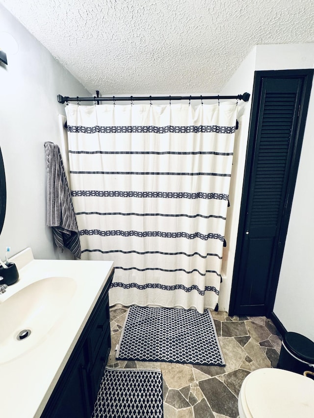 6002 Edmonton Rd, Columbia, KY 42728 - bathroom with vanity, a textured ceiling, toilet, a shower with shower curtain, and stone finish floors