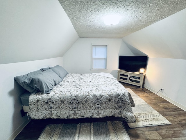 6002 Edmonton Rd, Columbia, KY 42728 - bedroom with baseboards, wood finished floors, vaulted ceiling, and a textured ceiling