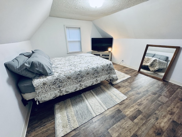 6002 Edmonton Rd, Columbia, KY 42728 - bedroom featuring a textured ceiling, vaulted ceiling, wood finished floors, and baseboards
