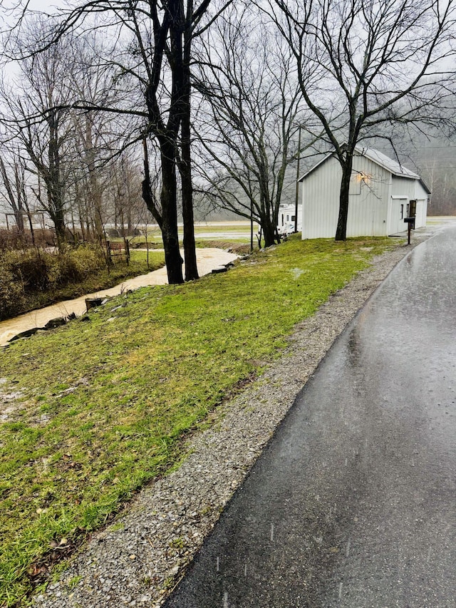 6002 Edmonton Rd, Columbia, KY 42728 - view of green lawn with an outdoor structure and a pole building