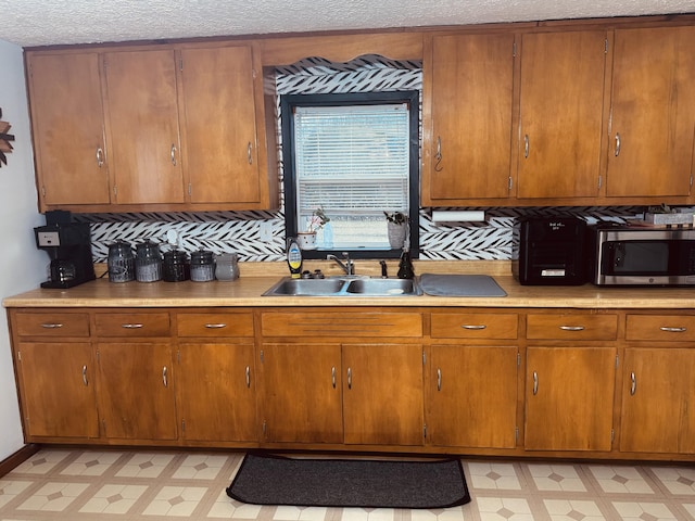 6002 Edmonton Rd, Columbia, KY 42728 - kitchen with stainless steel microwave, light floors, a sink, light countertops, and a textured ceiling