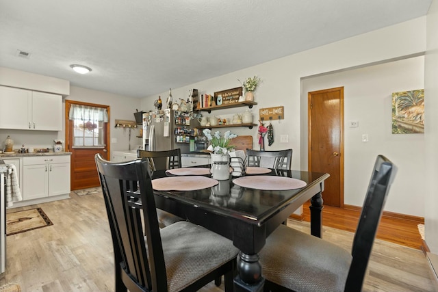 dining area featuring light wood-type flooring