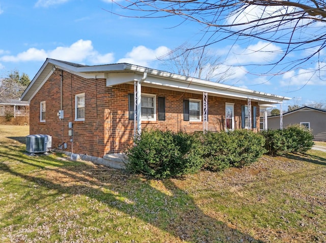 view of home's exterior with a yard and central air condition unit