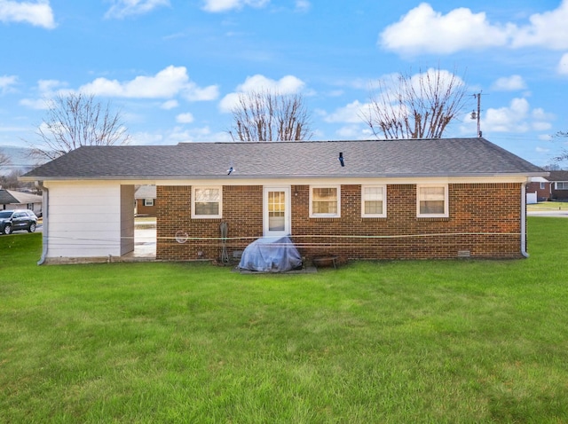 rear view of house with a lawn