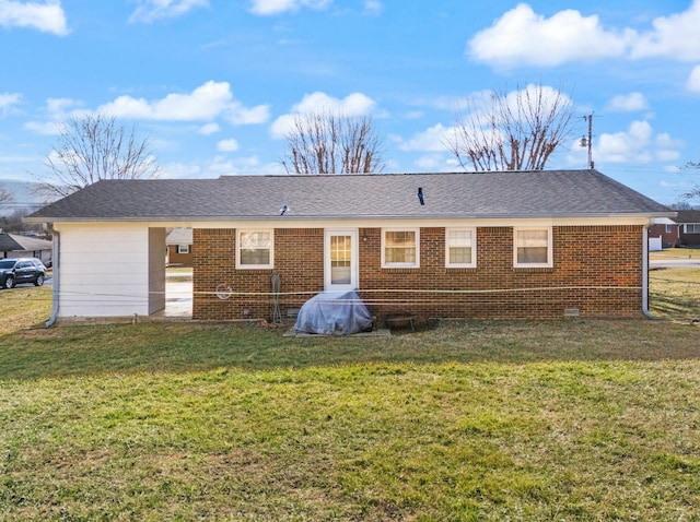 rear view of house featuring a lawn