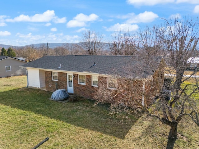 rear view of property featuring a yard