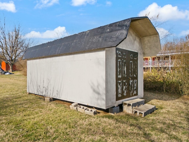 view of outbuilding featuring a yard