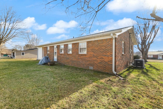 rear view of house featuring a yard and cooling unit