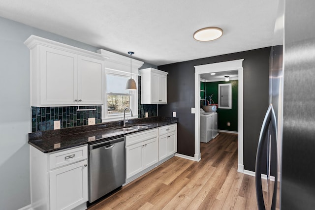 kitchen featuring a sink, white cabinetry, stainless steel dishwasher, and decorative light fixtures