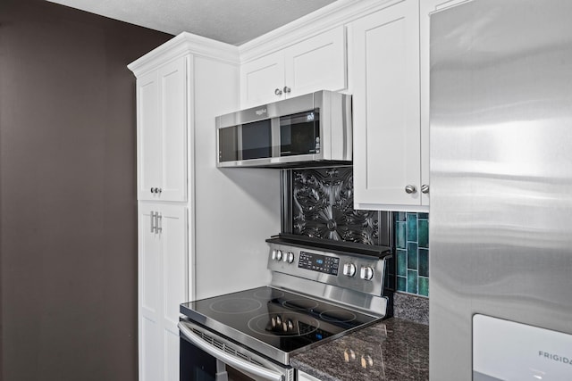 665 Linda Ave, Danville, KY 40422 - kitchen with appliances with stainless steel finishes, decorative backsplash, white cabinets, and dark stone counters