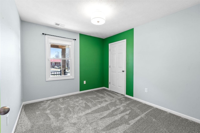 unfurnished bedroom featuring carpet, visible vents, and baseboards