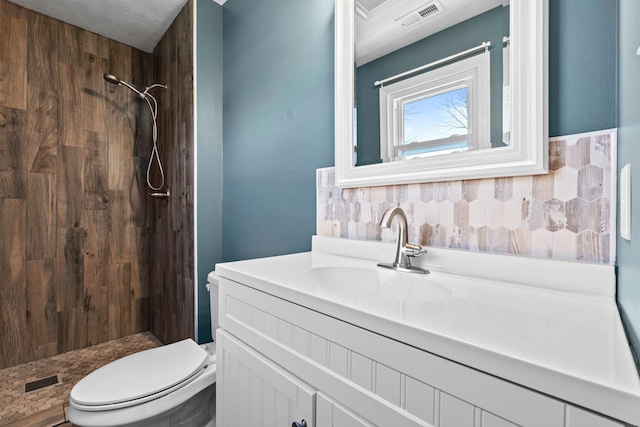 full bathroom featuring visible vents, a shower stall, toilet, and vanity