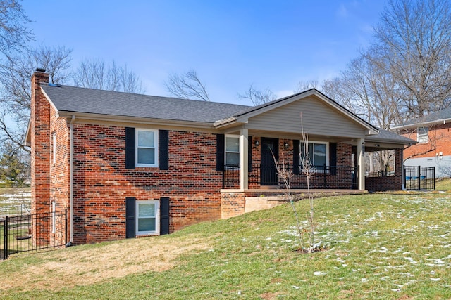 single story home featuring a front yard, fence, and brick siding