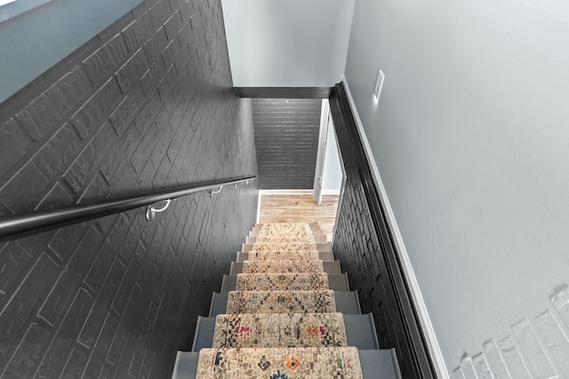 stairs featuring wood finished floors