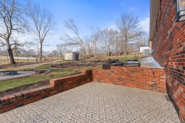 view of patio / terrace featuring a storage shed, an outdoor structure, and fence