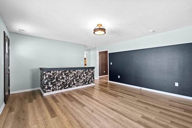 unfurnished room featuring baseboards and wood finished floors