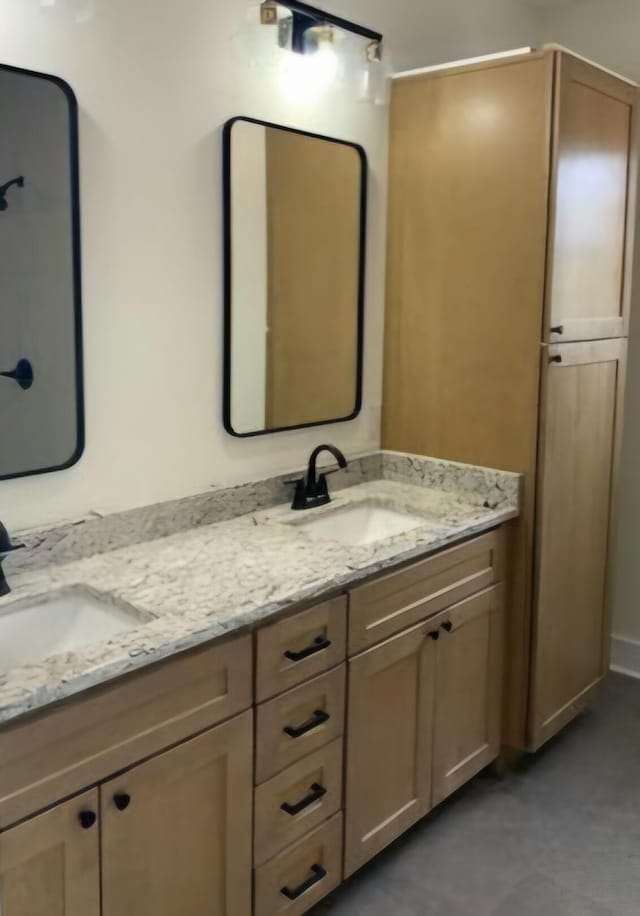 full bathroom featuring double vanity and a sink