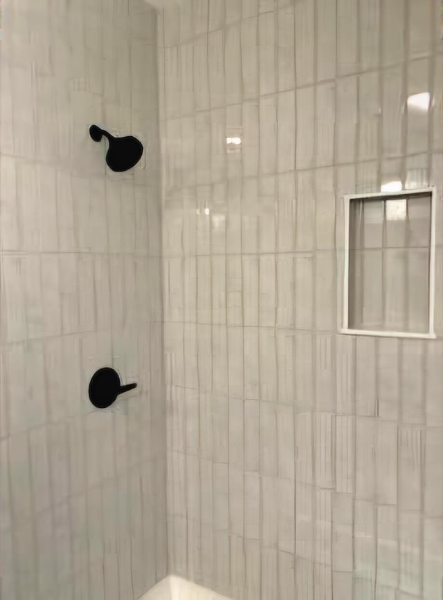 bathroom with tiled shower