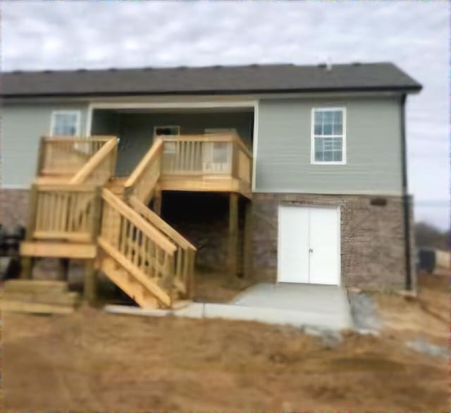 back of house with stairs