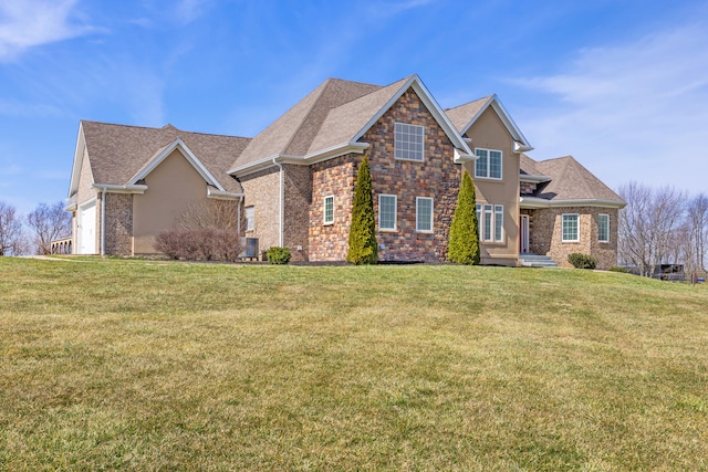 traditional-style house featuring a front lawn, roof with shingles, stucco siding, a garage, and stone siding