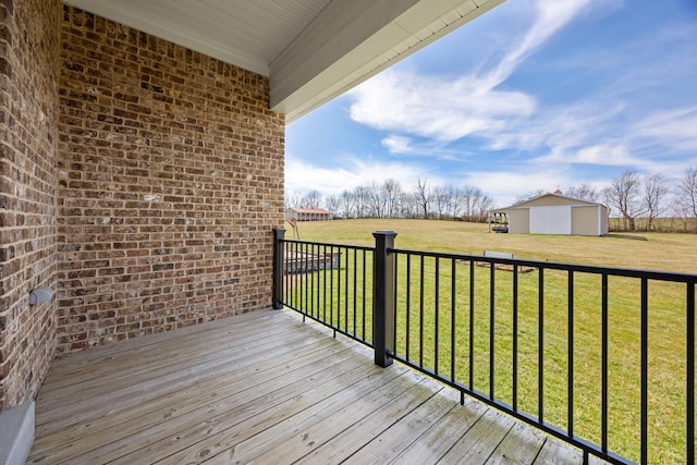 deck featuring an outbuilding and a lawn