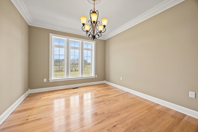 unfurnished room with a chandelier, baseboards, light wood-style flooring, and crown molding