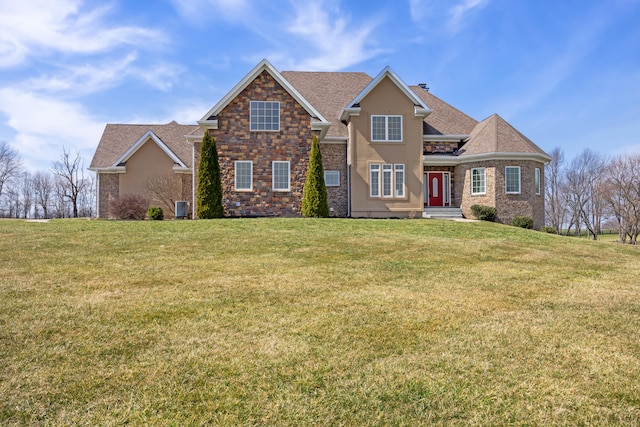 traditional-style home featuring stone siding, stucco siding, and a front lawn