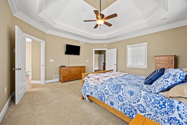 carpeted bedroom with a tray ceiling, visible vents, baseboards, and ornamental molding