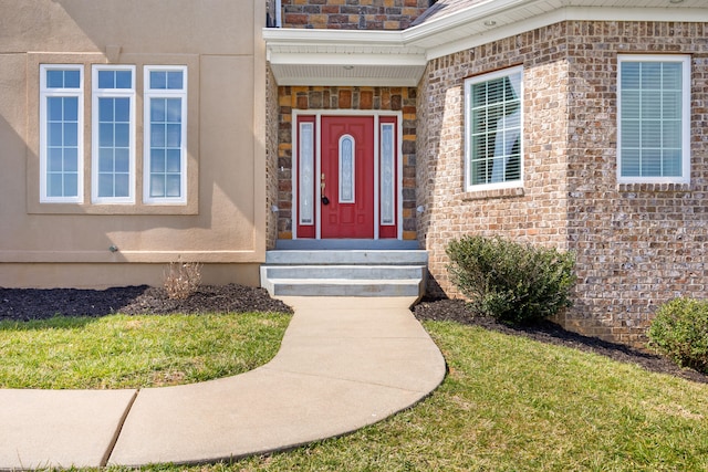 property entrance featuring brick siding