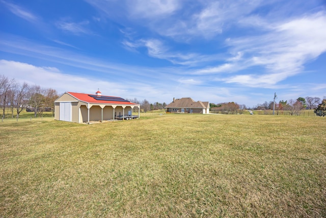 view of yard featuring an outbuilding and a detached garage