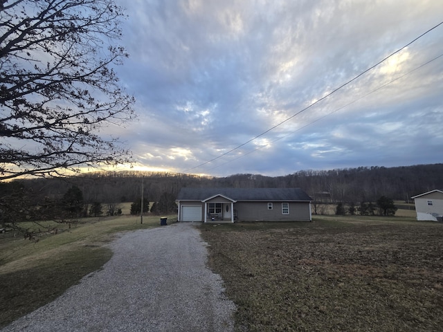 single story home with a garage and driveway