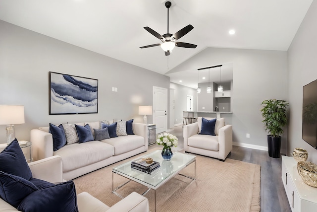 living room with hardwood / wood-style flooring, lofted ceiling, and ceiling fan