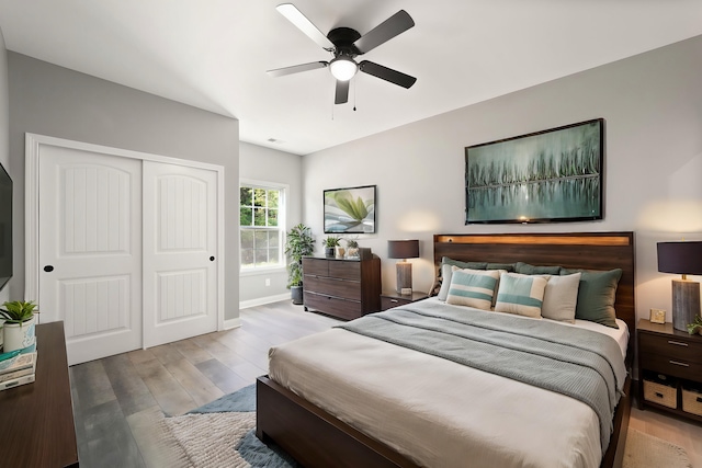 bedroom with ceiling fan, a closet, and light hardwood / wood-style flooring