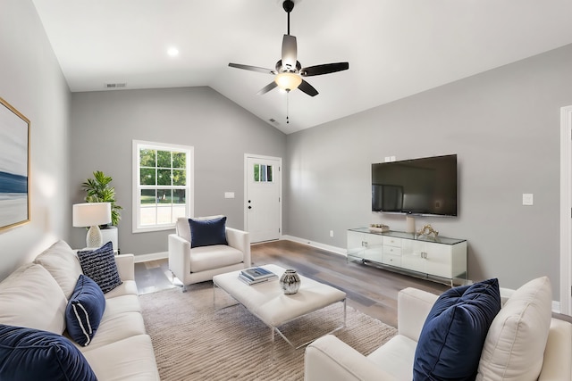 living room with vaulted ceiling, hardwood / wood-style floors, and ceiling fan