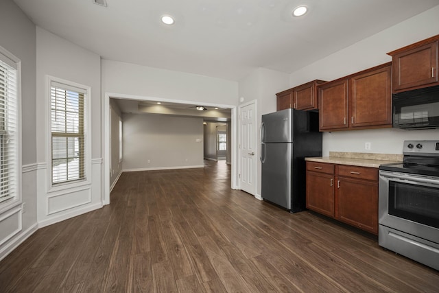 kitchen featuring recessed lighting, baseboards, light countertops, appliances with stainless steel finishes, and dark wood finished floors