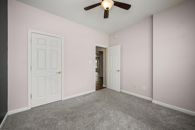 unfurnished bedroom with carpet, ceiling fan, and baseboards