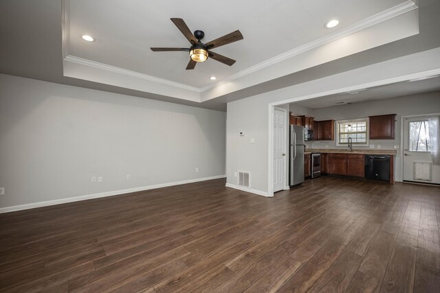 unfurnished living room featuring dark wood-style flooring, a raised ceiling, visible vents, and baseboards