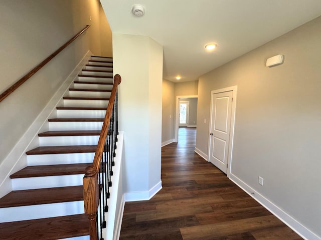 staircase with wood-type flooring