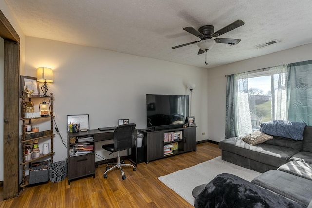 office area with hardwood / wood-style flooring, ceiling fan, and a textured ceiling