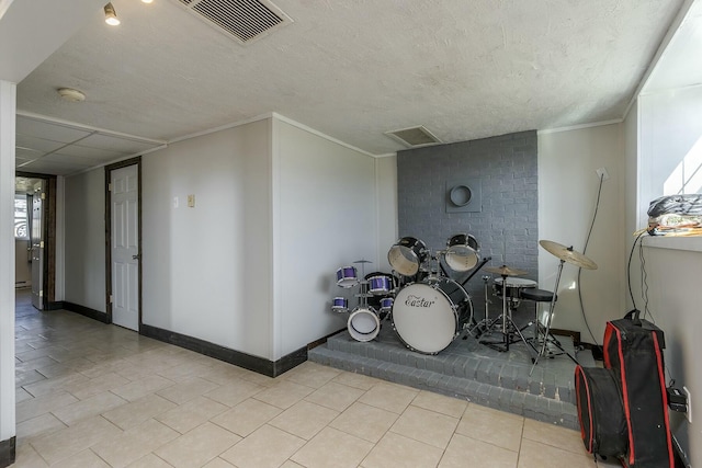 interior space with ornamental molding, light tile patterned floors, and a textured ceiling