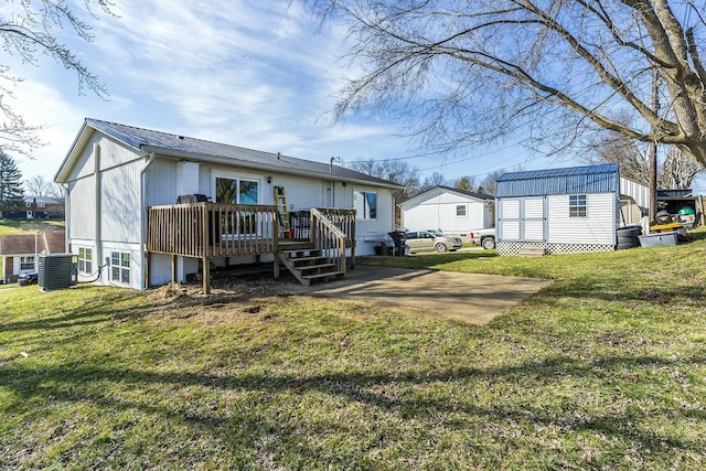 back of property with central AC unit, a storage shed, a lawn, and a deck