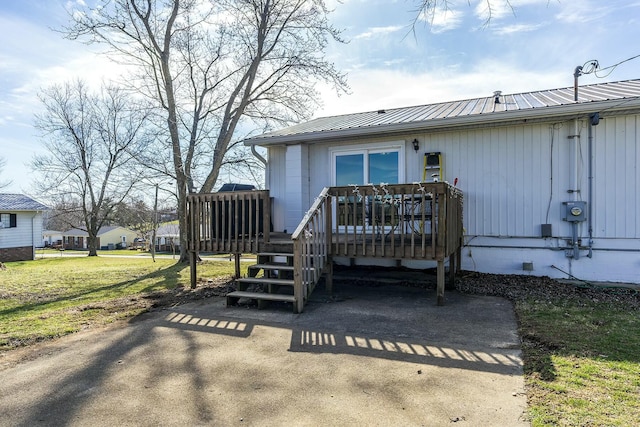 exterior space featuring a deck and a front lawn