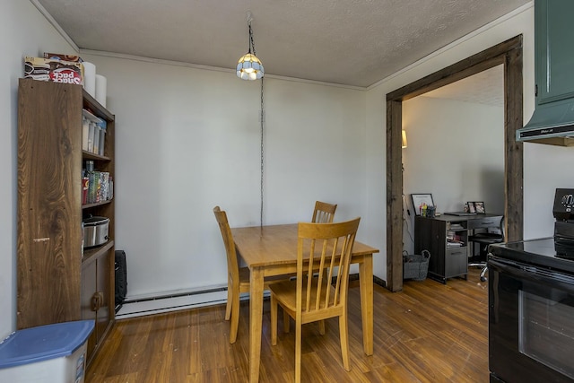 dining space featuring a baseboard radiator, hardwood / wood-style floors, and a textured ceiling