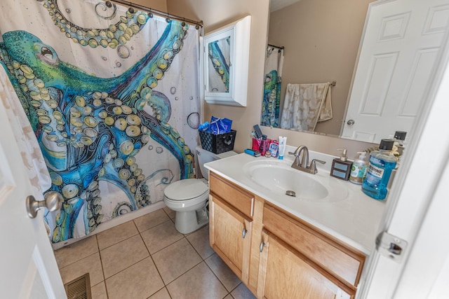 bathroom with toilet, vanity, visible vents, and tile patterned floors