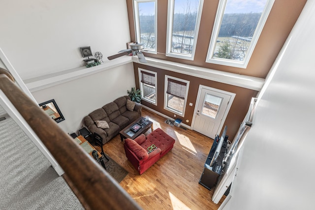 living room with ceiling fan and light wood-style flooring