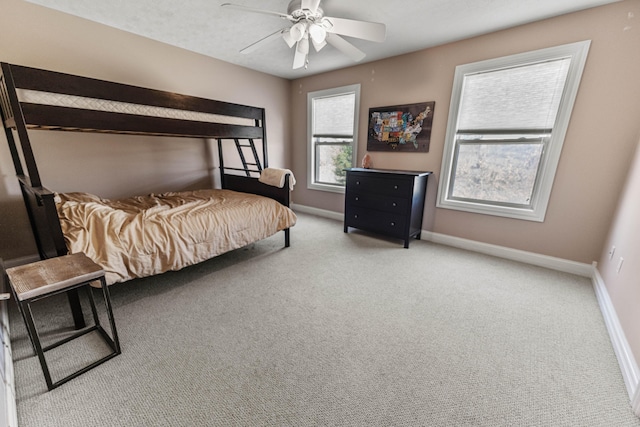 bedroom featuring light carpet, ceiling fan, and baseboards