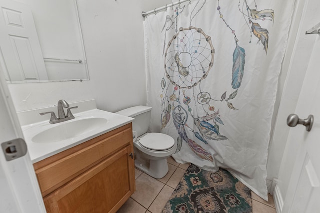 full bathroom featuring toilet, vanity, and tile patterned floors