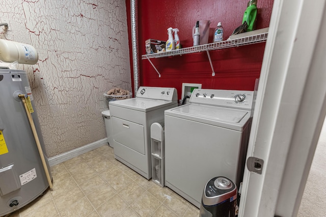 laundry area with a textured wall, laundry area, baseboards, water heater, and washing machine and clothes dryer